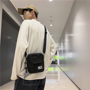 街头潮流情侣小挎包女ins韩版时尚休闲帆布包男士出街手机单肩包